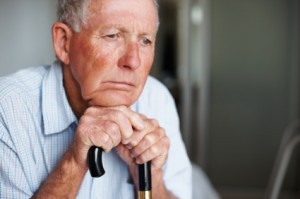 Closeup of an old man lost in thought , loneliness